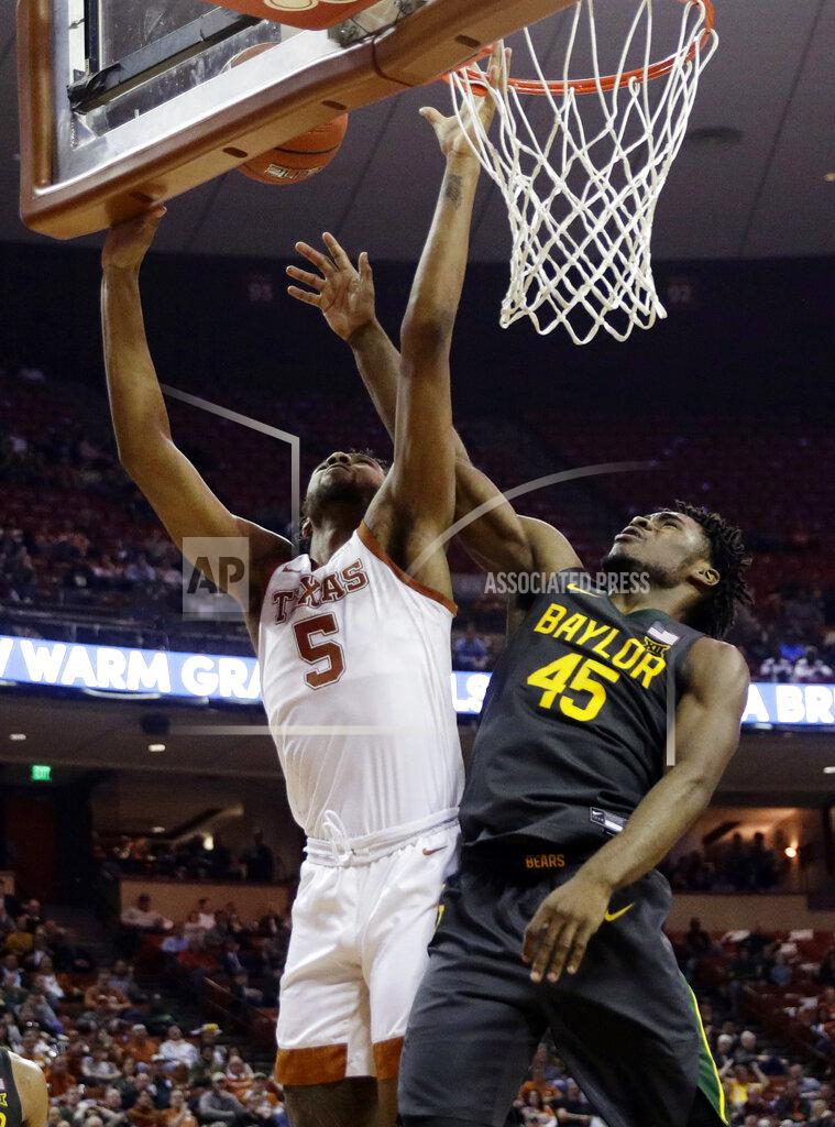 Eric Gay Texas forward Royce Hamm Jr. (5) is blocked by Baylor guard Davion Mitchell (45) during the second half of an NCAA college basketball game, Monday, Feb. 10, 2020, in Austin, Texas. (AP Photo/Eric Gay)