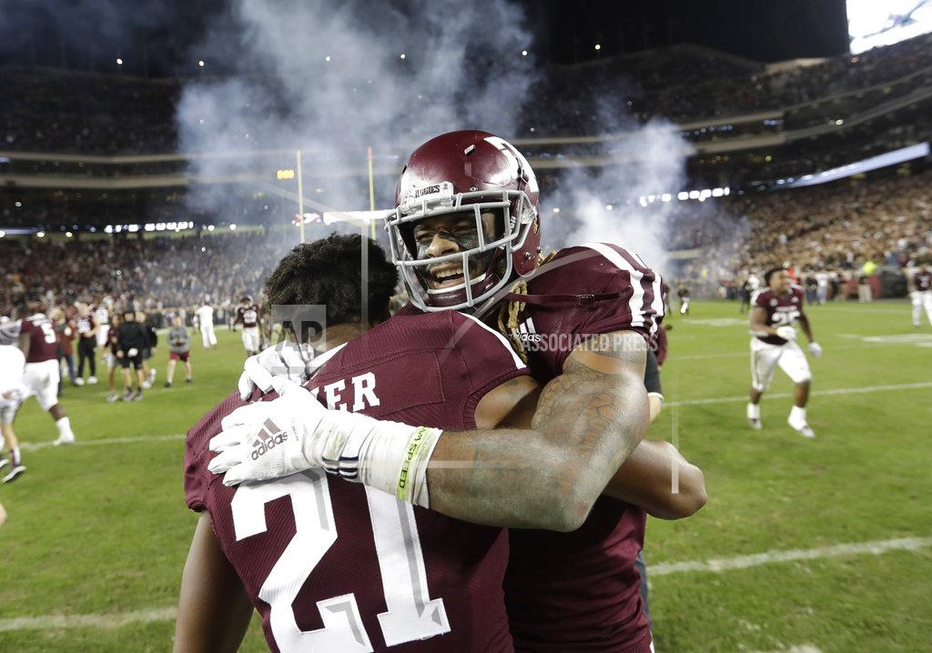 David J. Phillip Texas A&M wide receiver Kendrick Rogers, right, celebrates with Charles Oliver (21) after an NCAA college football game against LSU Saturday, Nov. 24, 2018, in College Station, Texas. Texas A&M won 74-72 in seven overtimes.(AP Photo/David J. Phillip)