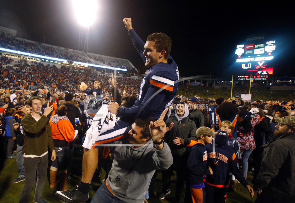 Steve Helber Virginia punter Lester Coleman (47) is lifted on to the shoulders of a fan as he celebrates his teams win over Miami after an NCAA college football game in Charlottesville, Va., Saturday, Oct. 13, 2018. Virginia defeated Miami 16-13. (AP Photo/Steve Helber)