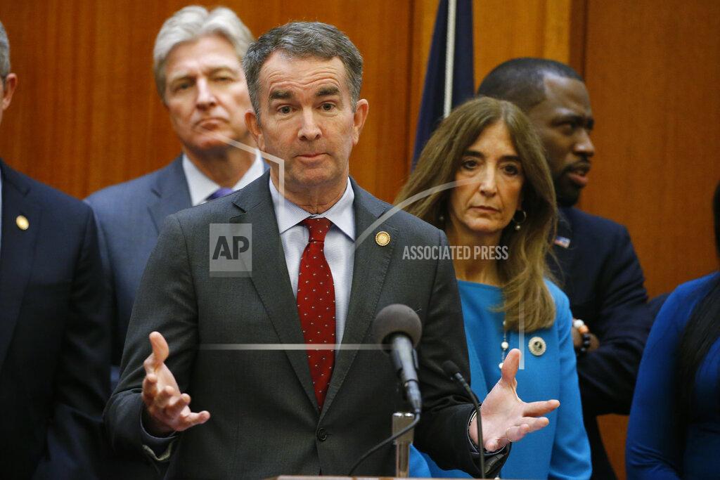 FILE - This March 12, 2020 file photo shows Virginia Gov. Ralph Northam, front, gesturing during a news conference as House speaker Eileen Filler-Corn, right, and Secretary of Public safety Brian Moran, left, look on at the Capitol in Richmond, Va. Northam plans to delay some long-sought Democratic priorities until more is known about how the pandemic will affect the economy, pushing back decisions on whether to give teachers and state workers raises, freeze in-state college tuition, and implement other new spending in the budget lawmakers passed only last month. Clark Mercer, the governor's chief of staff, said Tuesday, April 7, 2020 that too little is known about the impact on state revenues to move ahead now with billions of dollars in new spending, much of which would carry over into future years. (AP Photo/Steve Helber)