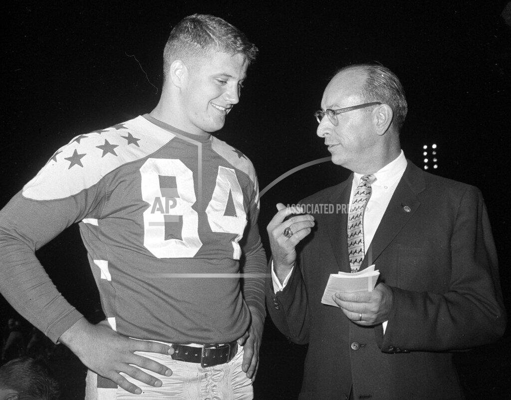 Edward Kitch FILE - In this Aug. 10, 1960, file photo, Jim Houston (84) of Ohio State is interviewed by Paul Hornung, sports editor of the Columbus Dispatch, at Soldier Field in Chicago. Houston's widow would keep notes on her husband's deteriorating condition in a three-ring binder so she would be prepared for the day when he needed full-time care. (AP Photo/Edward Kitch, File)