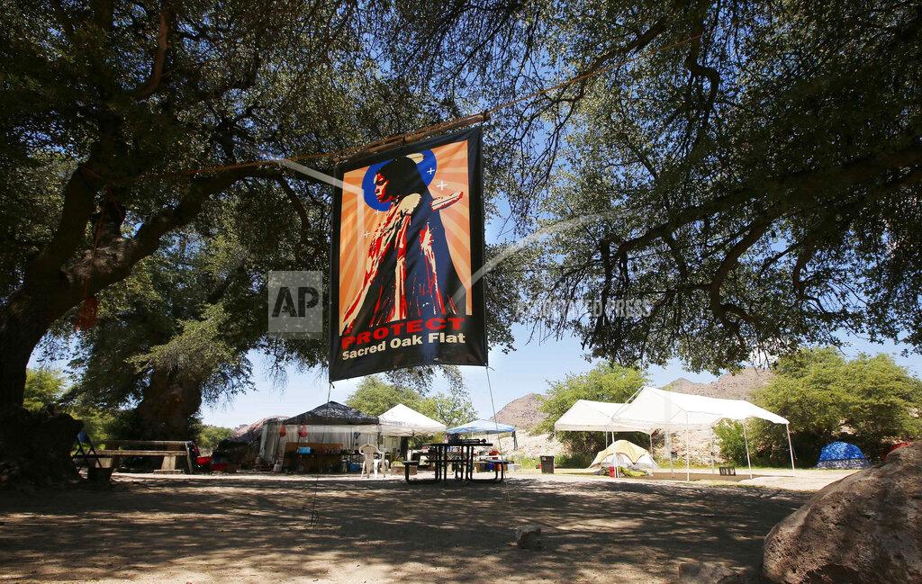 Ross D. Franklin FILE - This June 15, 2015 file photo shows an encampment belonging to protesters in the Oak Flat area of Superior, Ariz. The U.S. Forest Service released an environmental review Friday, Jan. 15, 2021, that paves the way for the creation of one of the largest copper mines in the United States, against the wishes of a group of Apaches who have been trying for years to stop the project. The mountainous land near Superior is known as Oak Flat or Chi'chil Bildagoteel. It's where Apaches have harvested medicinal plants, held coming-of-age ceremonies, and gathered acorns for generations. (AP Photo/Ross D. Franklin, File)