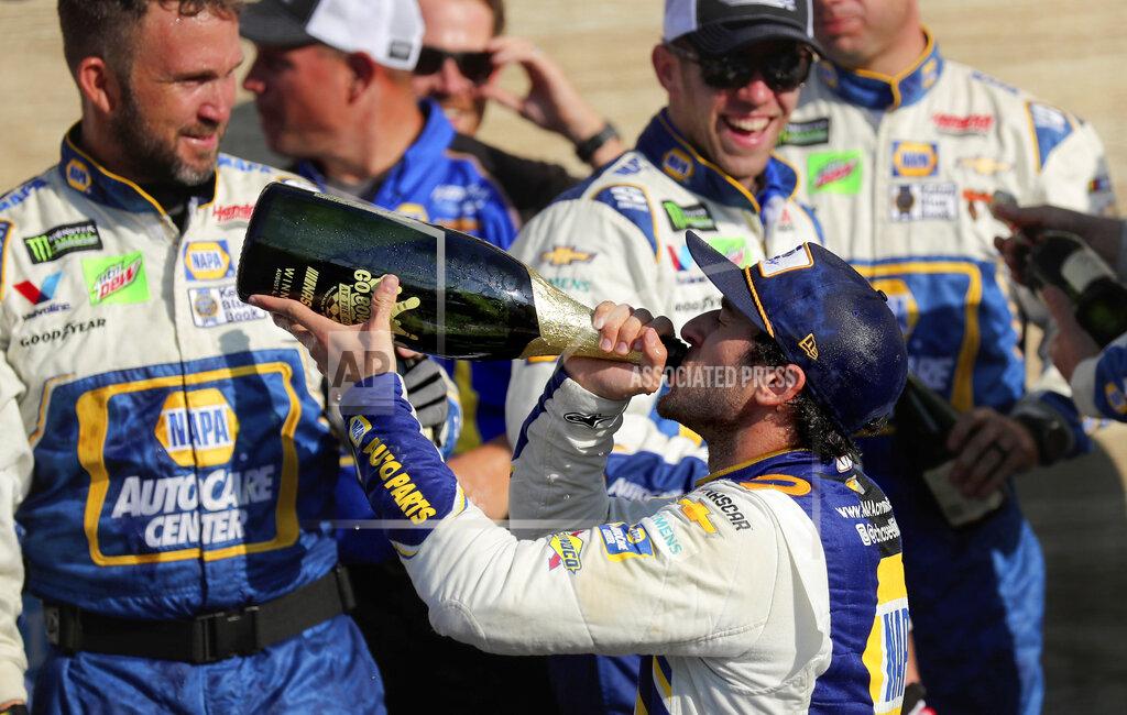 John Munson Chase Elliott celebrates his victory with his pit crew and champagne after winning the NASCAR Cup Series auto race at Watkins Glen International, Sunday, Aug. 4, 2019, in Watkins Glen, N.Y. (AP Photo/John Munson)