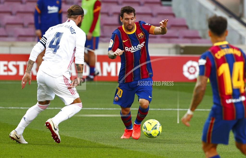 Joan Monfort Barcelona's Lionel Messi fights for the ball against Real Madrid's Sergio Ramos during the Spanish La Liga soccer match between FC Barcelona and Real Madrid at the Camp Nou stadium in Barcelona, Spain, Saturday, Oct. 24, 2020. (AP Photo/Joan Monfort)