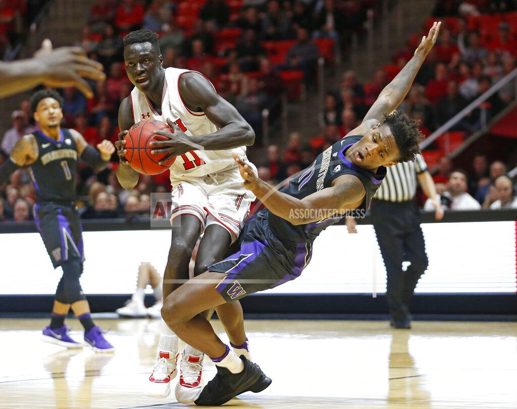 Rick Bowmer Washington forward Nahziah Carter, right, fouls Utah forward Both Gach during the second half of an NCAA college basketball game Thursday, Jan., 10, 2019, in Salt Lake City. (AP Photo/Rick Bowmer)