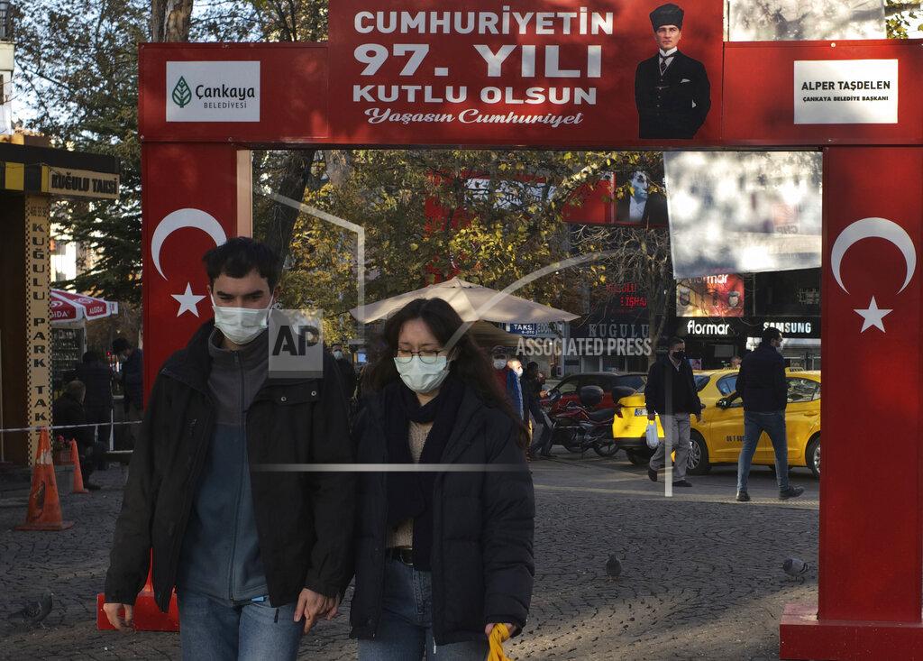 Burhan Ozbilici People wearing masks to help protect against the spread of coronavirus, walk along a popular street in Ankara, Turkey, Friday, Nov. 27, 2020. Turkey's COVID-19 fatalities continue to rise, hitting another record Sunday, Nov 29, 2020, with 185 new deaths. The Turkish government resumed reporting all positive cases this week after only reporting symptomatic patients for four months. Night-time curfews over the weekend are in effect for a second week across the country but media reports show packed public spaces during the day. (AP Photo/Burhan Ozbilici)