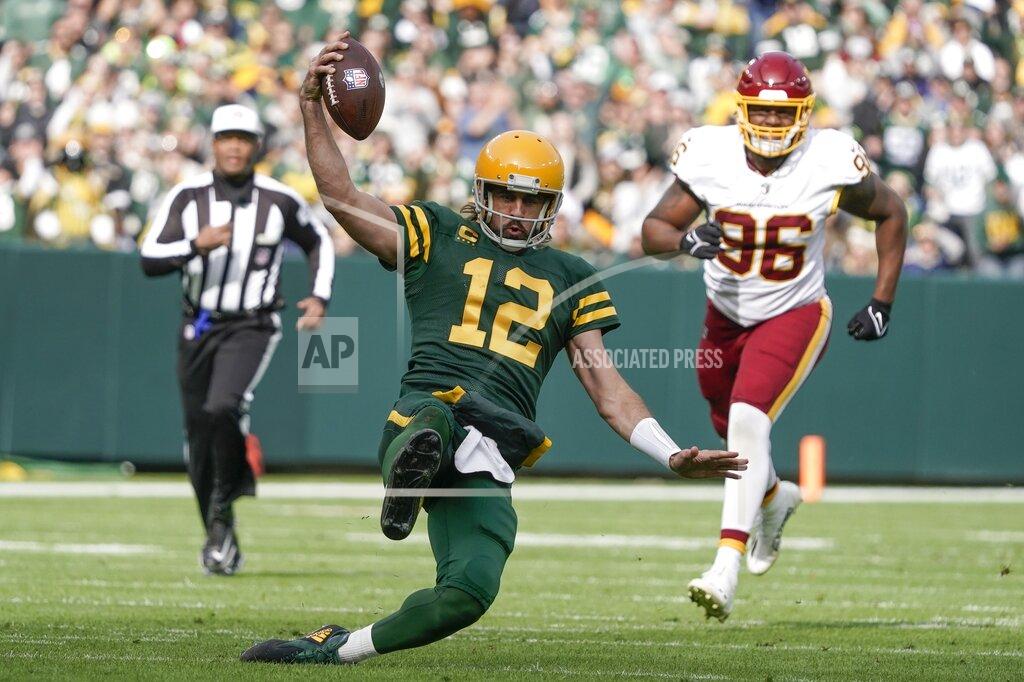 Morry Gash Green Bay Packers' Aaron Rodgers runs for a first down during the first half of an NFL football game against the Washington Football Team Sunday, Oct. 24, 2021, in Green Bay, Wis. (AP Photo/Morry Gash)