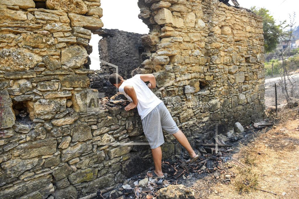 Uncredited A man looks at the destruction caused by wildfires near the Mediterranean coastal town of Manavgat, Antalya, Turkey, Friday, July 30, 2021. The death toll in a string of wildfires raging in southern Turkey rose to four, officials said Friday, as fire crews continued to battle blazes that burned down homes and forced people to evacuate settlements and beach resorts. Firefighters were still tackling wildfires in 14 locations in six provinces in Turkey's Mediterranean and southern Aegean region, President Recep Tayyip Erdogan told reporters. (AP Photo)