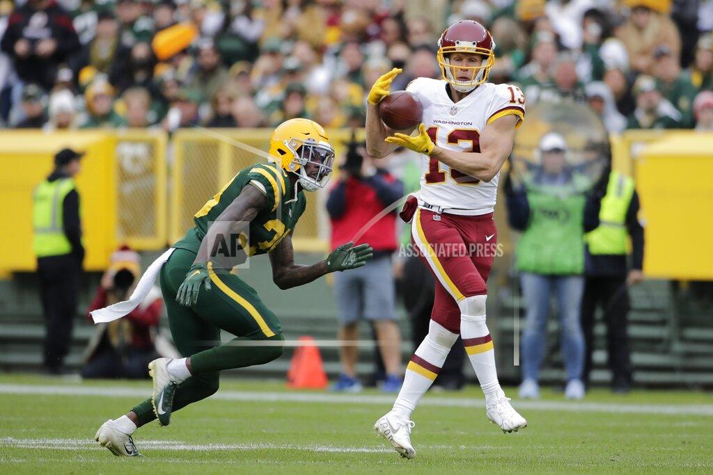 Aaron Gash Washington Football Team's Adam Humphries catches a pass in front of Green Bay Packers' Chandon Sullivan during the second half of an NFL football game Sunday, Oct. 24, 2021, in Green Bay, Wis. The Packers won 24-10. (AP Photo/Aaron Gash)