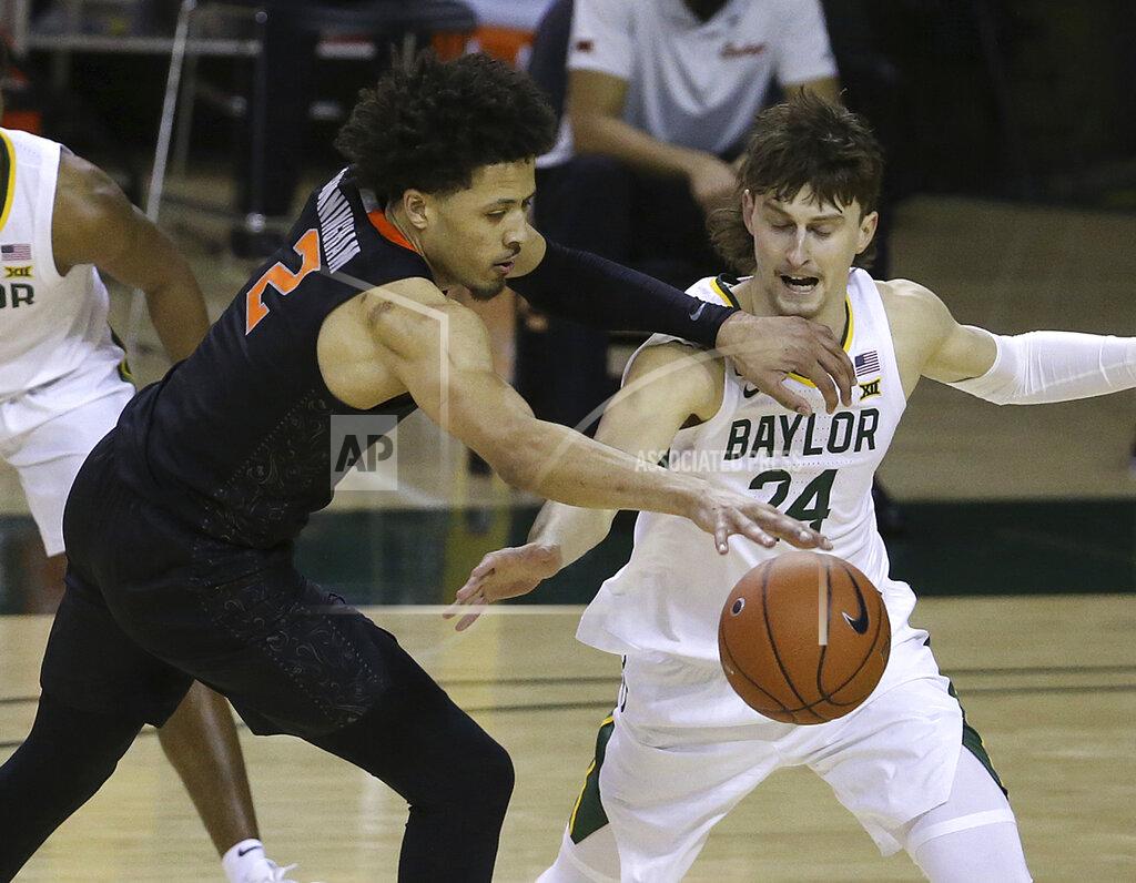 Jerry Larson Oklahoma State guard Cade Cunningham (2) has the ball striped by Baylor guard Matthew Mayer (24) in the second half of an NCAA college basketball game, Thursday, March 4, 2021, in Waco, Texas. (AP Photo/Jerry Larson)