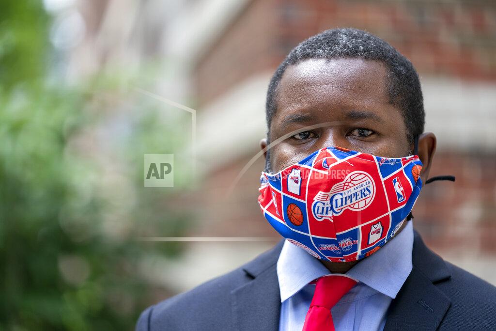 J. Scott Applewhite Economist Gbenga Ajilore poses for a photo outside his home in Washington, Friday, June 19, 2020. Ajilore believes the coronavirus pandemic is affecting the two largest U.S. generations, Baby Boomers and Millennials. For baby boomers, named for the post-World War II surge of births, that means those who retired or are nearing retirement age are seeing their retirement accounts appearing unreliable while their health is at high risk. Millennials, who became young adults in this century, are getting socked again as they were still recovering from the Great Recession. (AP Photo/J. Scott Applewhite)