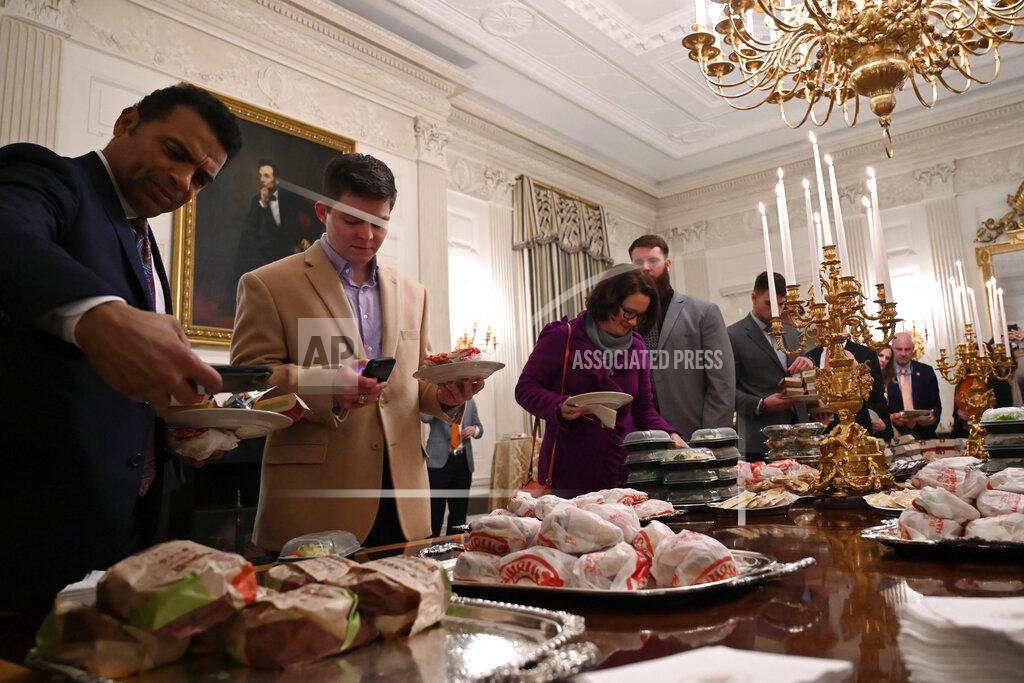 Susan Walsh Guests attending a reception for the Clemson Tigers grab fast food sandwiches in the State Dining Room of the White House in Washington, Monday, Jan. 14, 2019. (AP Photo/Susan Walsh)