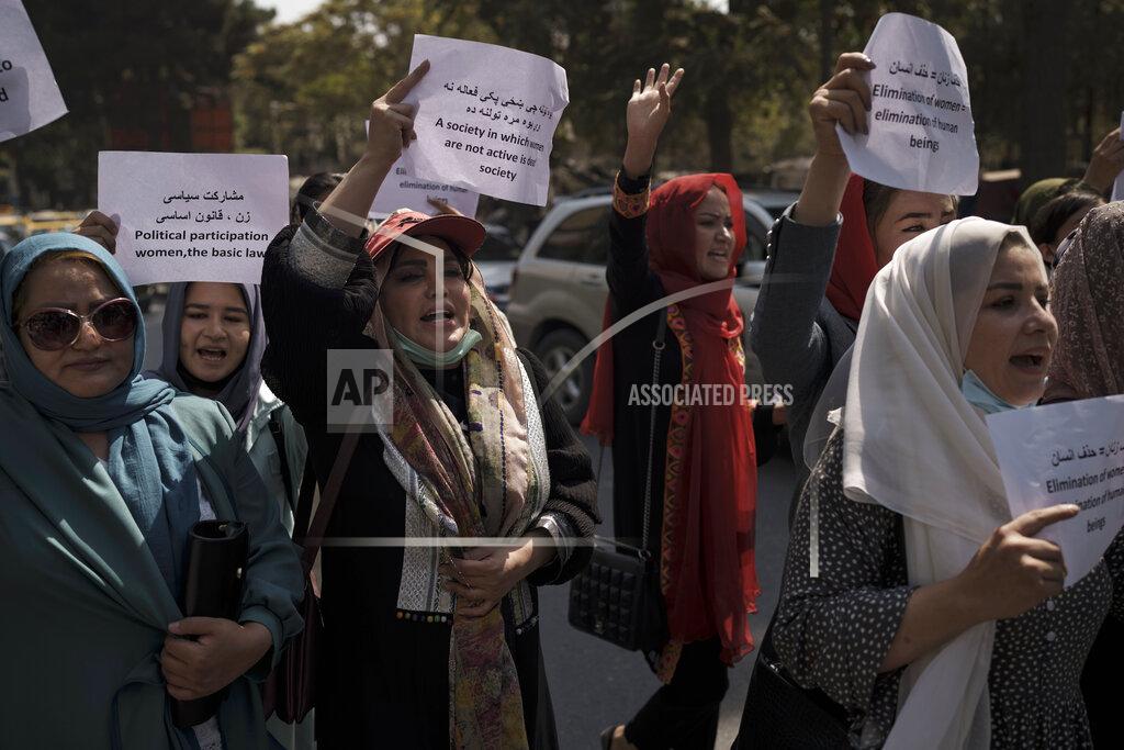 Uncredited Women march to demand their rights under the Taliban rule during a demonstration near the former Women's Affairs Ministry building in Kabul, Afghanistan, Sunday, Sept. 19, 2021. The interim mayor of Afghanistan’s capital said Sunday that many female city employees have been ordered to stay home by the country’s new Taliban rulers. (AP Photo)