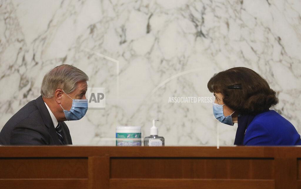 Leah Millis Chairman Lindsey Graham, R-S.C., left, and ranking member Dianne Feinstein, D-Calif., talk before the confirmation hearing for Supreme Court nominee Amy Coney Barrett at the Senate Judiciary Committee on Capitol Hill in Washington, Monday, Oct. 12, 2020. Leah Millis/Pool via AP)