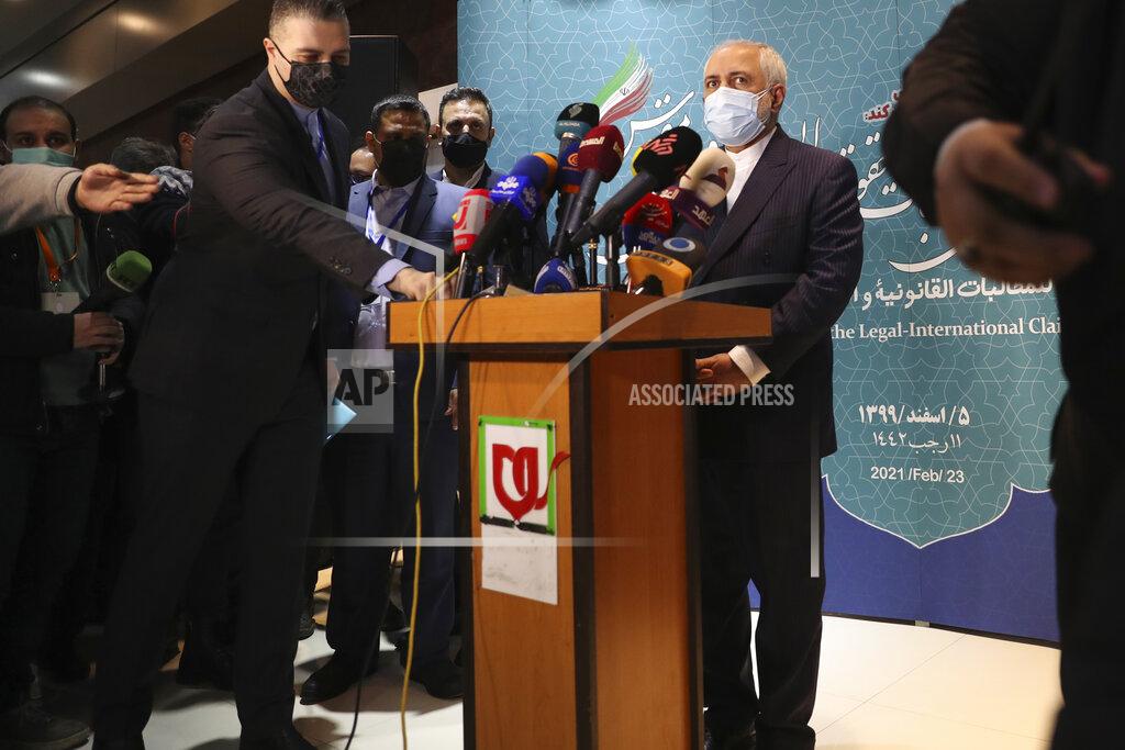 Vahid Salemi Iran's Foreign Minister Mohammad Javad Zarif prepares to speak with journalists following a conference in Tehran, Iran, Tuesday, Feb. 23, 2021. Iran's foreign minister says the country has started implementing a law passed by the parliament to curb UN inspections into its nuclear program. Zarif reiterated that Iran would no longer share surveillance footage of its nuclear facilities with the U.N. agency. (AP Photo/Vahid Salemi)