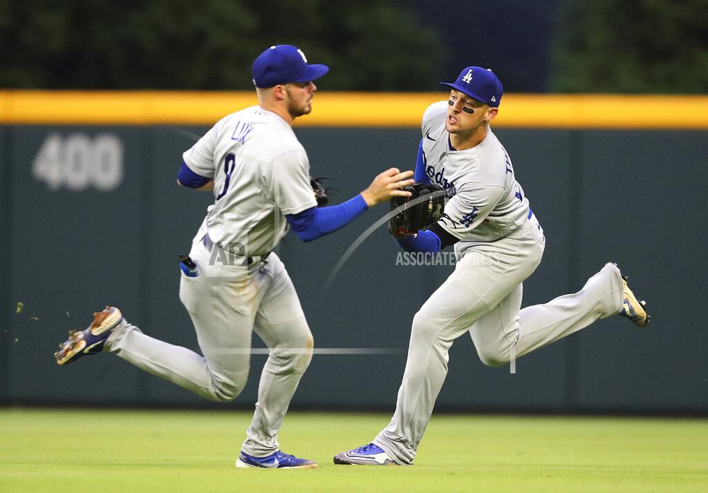 Curtis Compton Los Angles Dodgers outfielder Trace Thompson, right, runs down a fly ball for the out on Atlanta Braves' Orlando Arcia's fly ball and avoids the collision with Dodgers' Gavin Lux during the fourth inning of a baseball game, Sunday, June 26, 2022, in Atlanta. (Curtis Compton/Atlanta Journal-Constitution via AP)