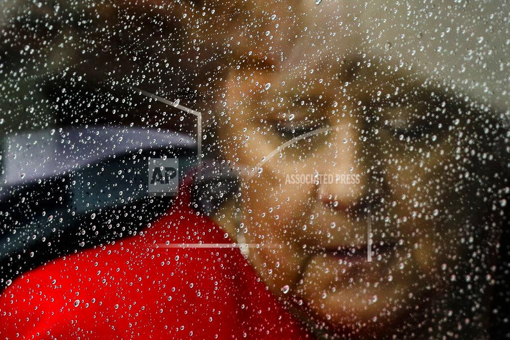 Markus Schreiber FOR HOLD - FILE - In this Friday, July 12, 2019 file photo, rain drops cover the window of a car as German Chancellor Angela Merkel arrives for the opening of the James-Simon-Galerie of at the Museum's Island in Berlin. Germany prepares for the Sept. 26 election that will determine who succeeds Chancellor Angela Merkel at the helm of Europe's biggest economy, satisfaction with the old government and expectations of the new one vary widely across the country of 83 million. (AP Photo/Markus Schreiber, File)