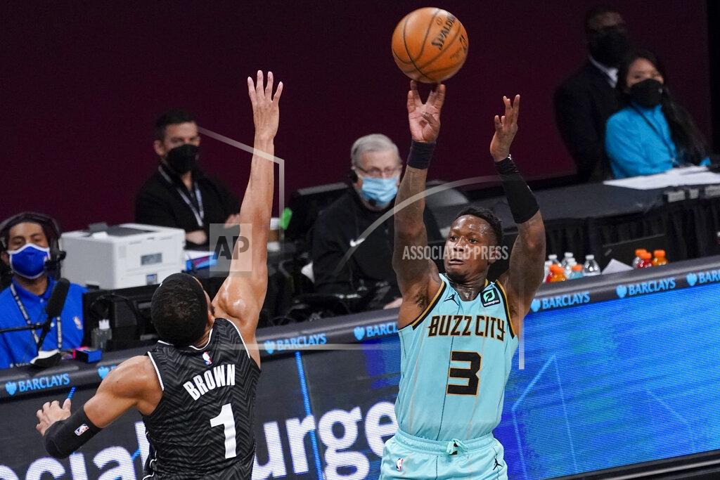 Mary Altaffer Charlotte Hornets guard Terry Rozier (3) shoots a 3-pointer Brooklyn Nets forward Bruce Brown (1) during the second half of an NBA basketball game Friday, April 16, 2021, in New York. (AP Photo/Mary Altaffer)