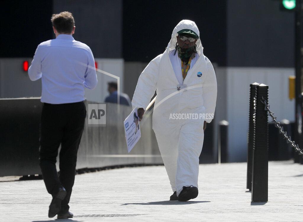 Frank Augstein A protestor demanding more PPE for healthcare workers, walks alongside Parliament in central London, Wednesday April 22, 2020 during the coronavirus lockdown. (AP Photo/Frank Augstein)