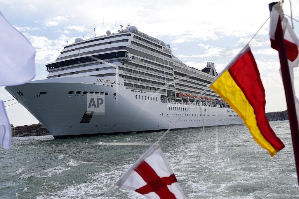 Antonio Calanni The the 92,409-ton, 16-deck MSC Orchestra cruise ship exits the lagoon as it leaves Venice, Italy, Saturday, June 5, 2021. The first cruise ship leaving Venice since the pandemic is set to depart Saturday amid protests by activists demanding that the enormous ships be permanently rerouted out the fragile lagoon, especially Giudecca Canal through the city's historic center, due to environmental and safety risks. (AP Photo/Antonio Calanni)