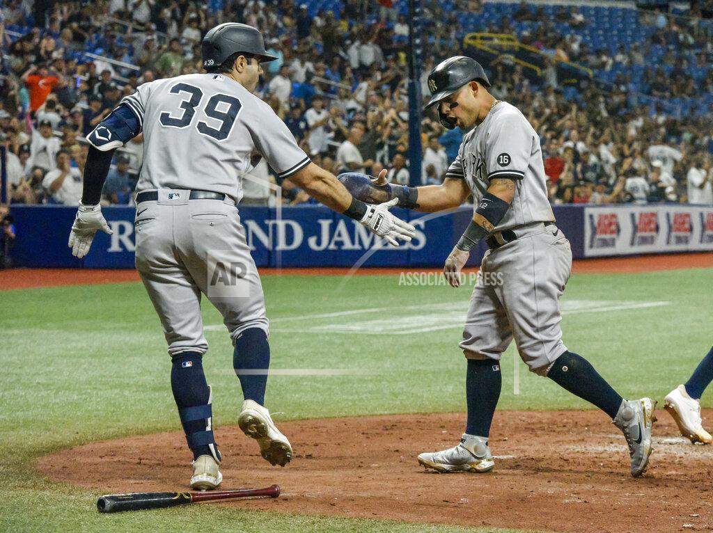 Steve Nesius New York Yankees on-deck batter Ryan LaMarre (39) congratulates Rougned Odor, who scored on Gio Urshela's two-run double against the Tampa Bay Rays during the fifth inning of a baseball game Tuesday, July 27, 2021, in St. Petersburg, Fla. (AP Photo/Steve Nesius)