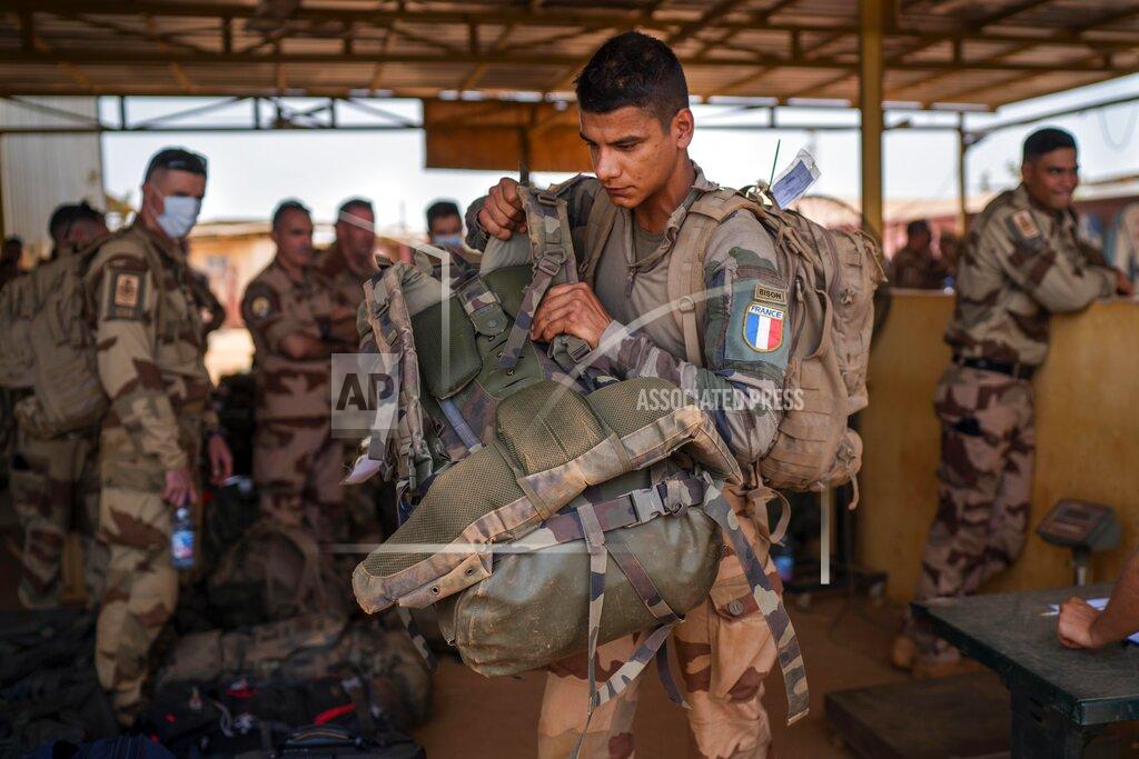 Uncredited French Barkhane force soldiers who wrapped up a four-month tour of duty in the Sahel leave their base in Gao, Mali Wednesday June 9, 2021. France has suspended joint military operations with Malian forces until the junta led by Col. Assimi Goita, who retook control of Mali's transitional government May 24, complies with international demands to restore civilian rule. (AP Photo/Jerome Delay)