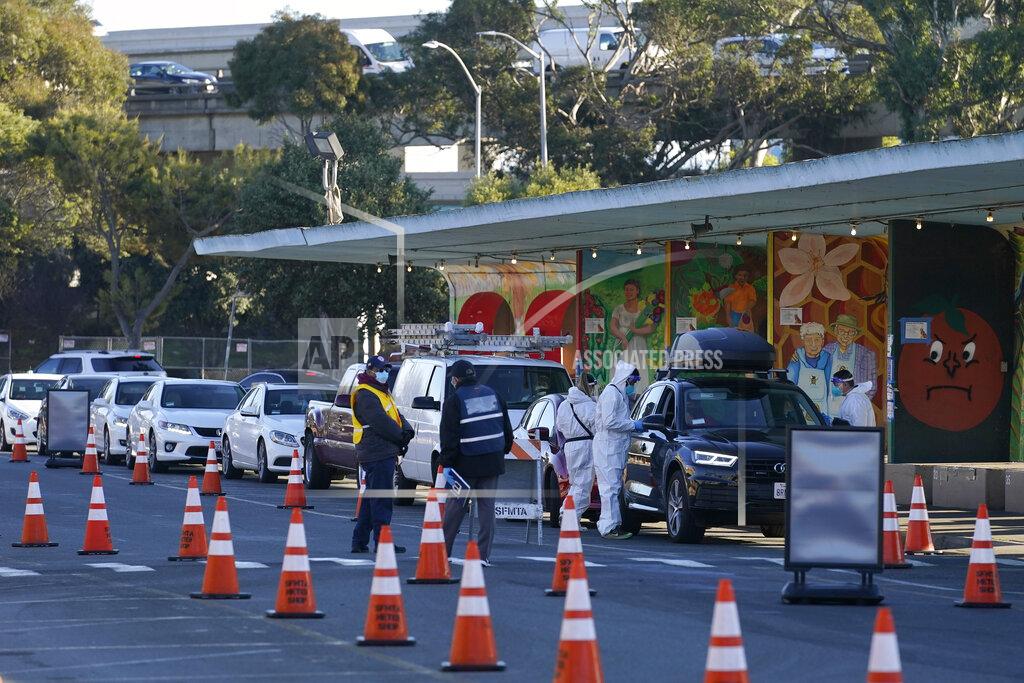 Jeff Chiu FILE - In this Dec. 22, 2020 file photo cars line up as healthcare workers ready COVID-19 tests at the CityTestSF at Alemany Farmer's Market location during the coronavirus pandemic in San Francisco. California became the first state to record 2 million confirmed coronavirus cases, reaching the milestone on Christmas Eve as close to the entire state was under a strict stay-at-home order and hospitals were flooded with the largest crush of cases since the pandemic began.(AP Photo/Jeff Chiu)