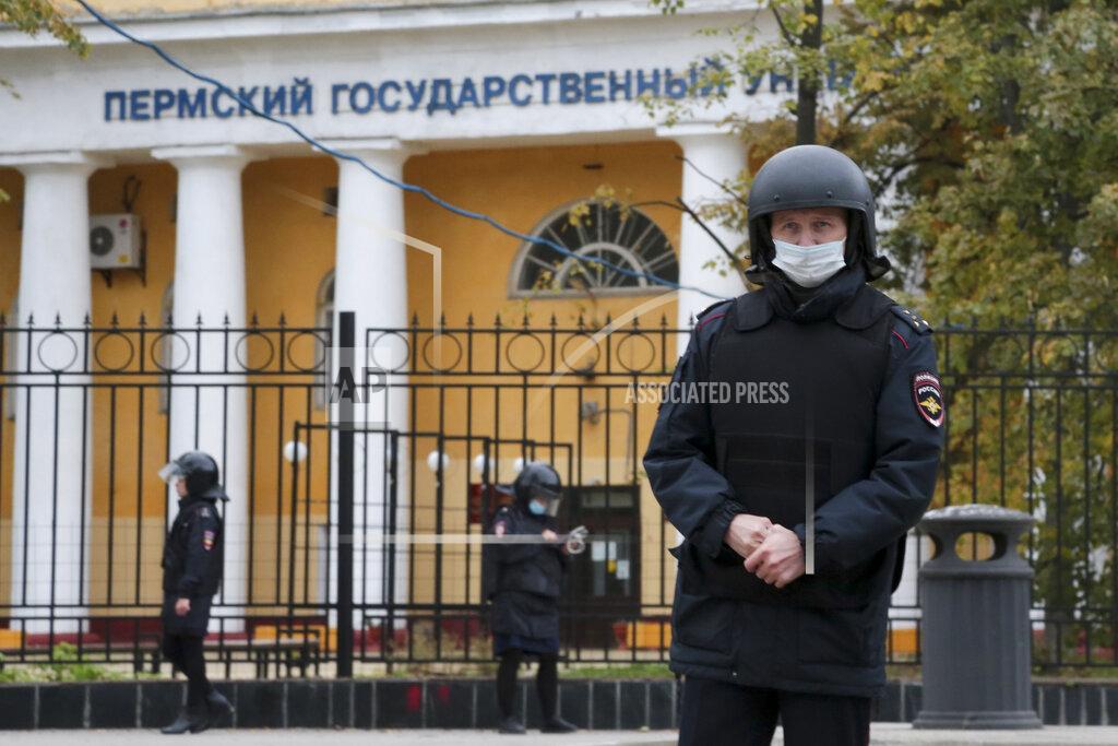 Uncredited Police officers guard an area in front of the Perm State University in Perm, about 1,100 kilometers (700 miles) east of Moscow, Russia, Monday, Sept. 20, 2021. A gunman opened fire in a university in the Russian city of Perm on Monday morning, leaving at least eight people dead and others wounded, according to Russia's Investigative Committee. (AP Photo)