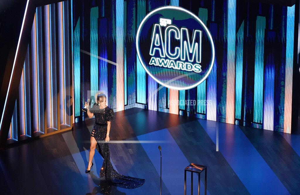 Mark Humphrey FILE - Carrie Underwood accepts the entertainer of the year award in a tie with Thomas Rhett during the 55th annual Academy of Country Music Awards at the Grand Ole Opry House in Nashville, Tenn. on Sept. 16, 2020. The Academy of Country Music Awards will be held again in Nashville for a second time, holding its awards show at three different venues. The show will air on April 18 on CBS from the Grand Ole Opry House, the Ryman Auditorium and the Bluebird Cafe. The show is normally held in Las Vegas every April, but moved to Music City last year when the coronavirus pandemic delayed their show to last September. (AP Photo/Mark Humphrey, File)