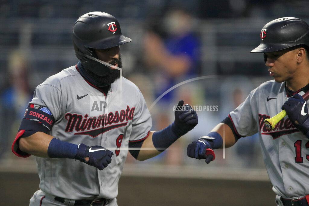 Orlin Wagner Minnesota Twins' Marwin Gonzalez (9) is congratulated by teammate Ehire Adrianza (13) after his solo home run during the fourth inning of a baseball game against the Kansas City Royals at Kauffman Stadium in Kansas City, Mo., Friday, Aug. 7, 2020. (AP Photo/Orlin Wagner)