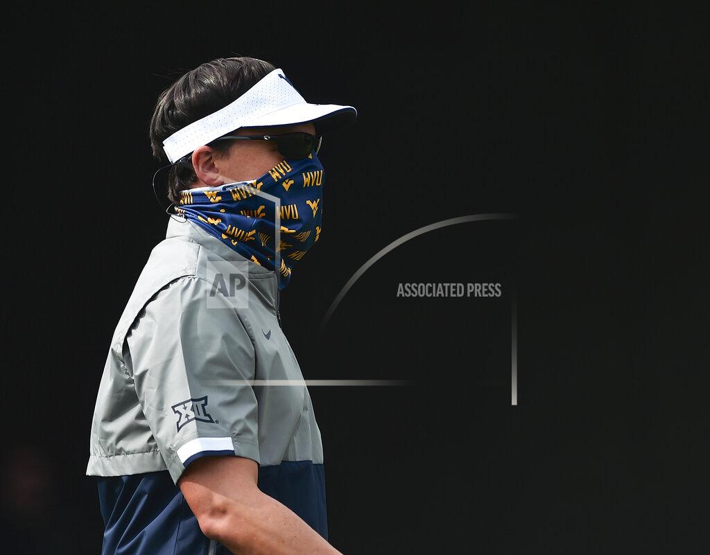 William Wotring/ The Dominion Post West Virginia head coach Neal Brown makes his way onto the field during warmups before an NCAA college football game against Eastern Kentucky on Saturday, Sept. 12, 2020, in Morgantown, W.Va. (William Wotring/The Dominion-Post via AP)