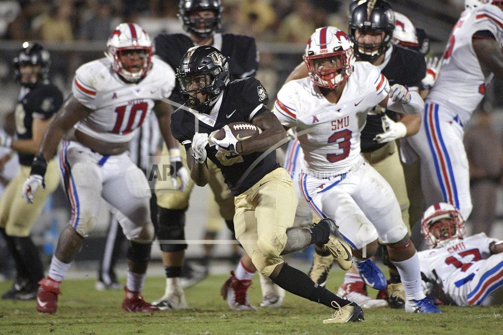 Phelan M. Ebenhack Central Florida running back Otis Anderson, center, breaks free for a 30-yard rushing touchdown past SMU defensive tackle Demerick Gary (10) and linebacker Delano Robinson (3) during the second half of an NCAA college football game Saturday, Oct. 6, 2018, in Orlando, Fla. UCF won 48-20. (AP Photo/Phelan M. Ebenhack)