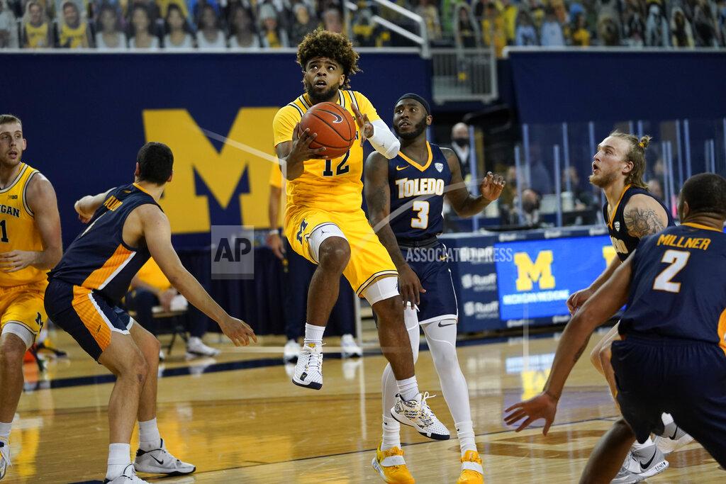Paul Sancya Michigan guard Mike Smith (12) drives against Toledo in the second half of an NCAA college basketball game in Ann Arbor, Mich., Wednesday, Dec. 9, 2020. (AP Photo/Paul Sancya)