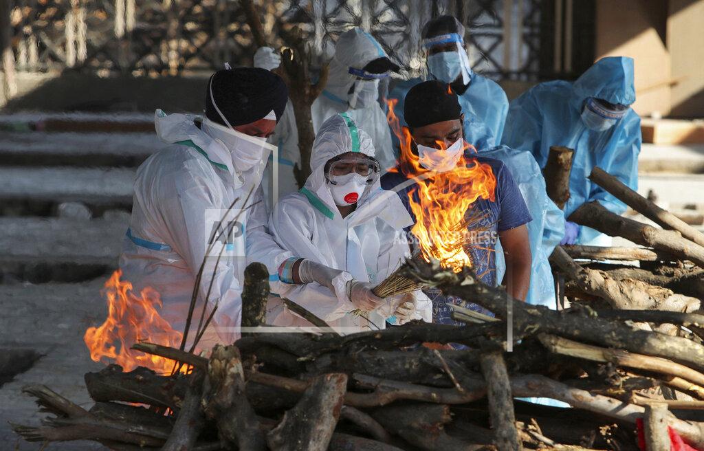Channi Anand FILE - In this April 26, 2021, file photo, family members of a person who died due to COVID-19 light the funeral pyre at a crematorium in Jammu, India. As deaths mount and a vaccine rollout falters badly, Prime Minister Narendra Modi has pushed much of the responsibility for fighting the outbreak onto unprepared and poorly equipped state governments. The crisis has badly dented Modi’s carefully cultivated image as an able technocrat. (AP Photo/Channi Anand, File)