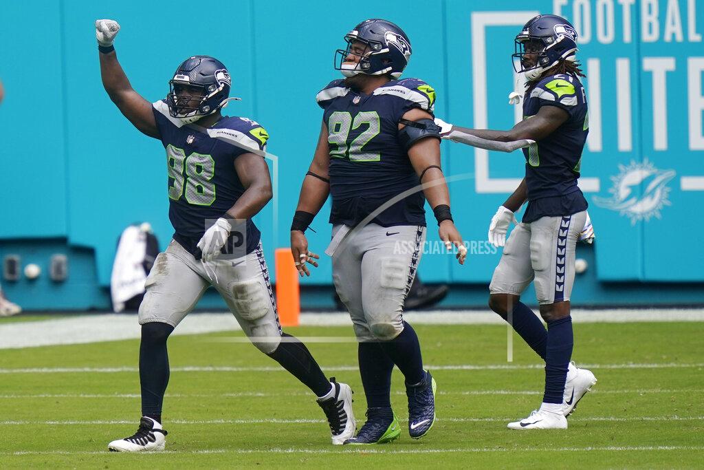 Lynne Sladky Seattle Seahawks defensive end Alton Robinson (98) celebrates after his tackle against Miami Dolphins running back Myles Gaskin (37) forced a field goal, during the second half of an NFL football game, Sunday, Oct. 4, 2020, in Miami Gardens, Fla. (AP Photo/Lynne Sladky)