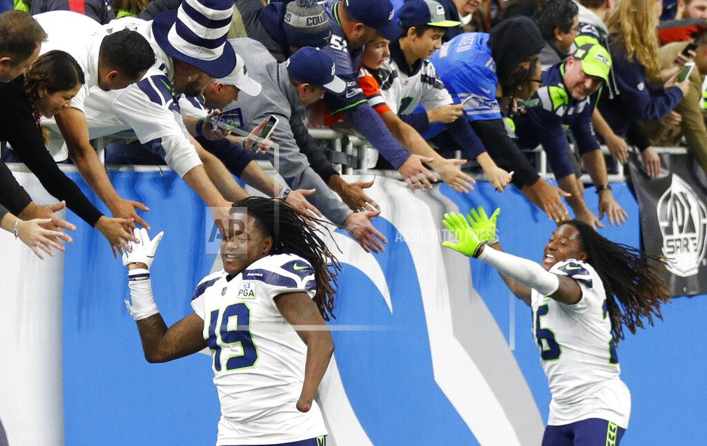 Paul Sancya FILE - In this Sunday, Oct. 28, 2018, file photo, Seattle Seahawks linebacker Shaquem Griffin (49) and cornerback Shaquill Griffin (26) shake hands with fans after an NFL football game against the Detroit Lions in Detroit. The NFL is partnering with three non-profit, non-partisan organizations to get out the vote as the league leverages its “Inspire Change” initiative. The program will support and encourage voting and civic engagement efforts of current and former NFL players, club and league personnel and fans beginning Friday, Aug. 7, 2020, until Election Day in November. The Griffins are at the forefront of the movement among players. (AP Photo/Paul Sancya, File)