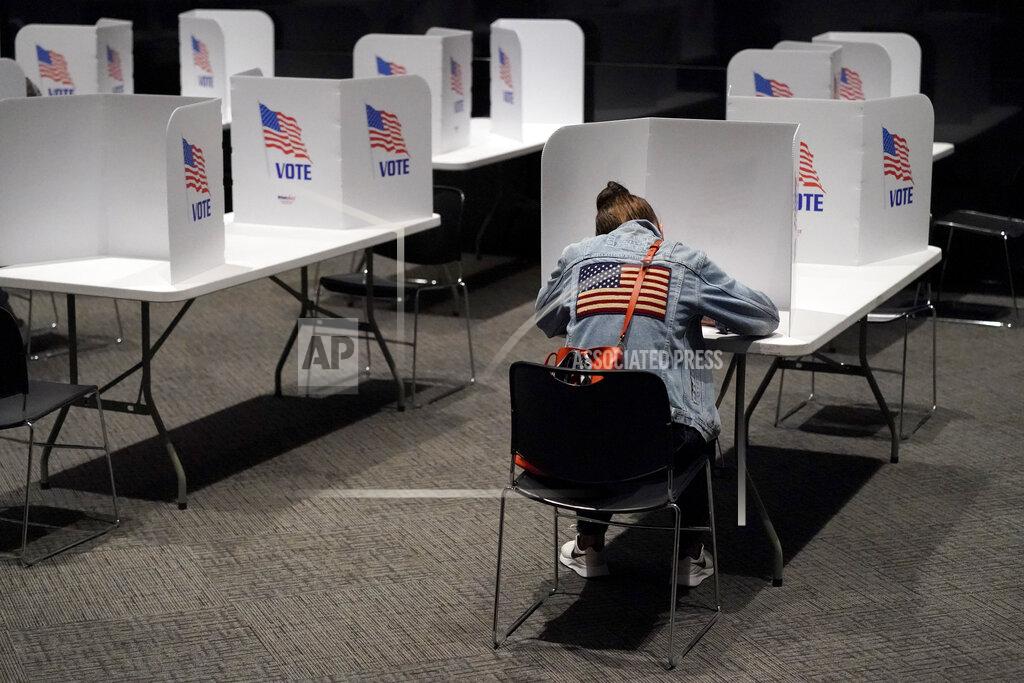 Charlie Riedel Laura Wooding votes at the National World War I museum on Election Day Tuesday, Nov. 3, 2020, in Kansas City, Mo. (AP Photo/Charlie Riedel)