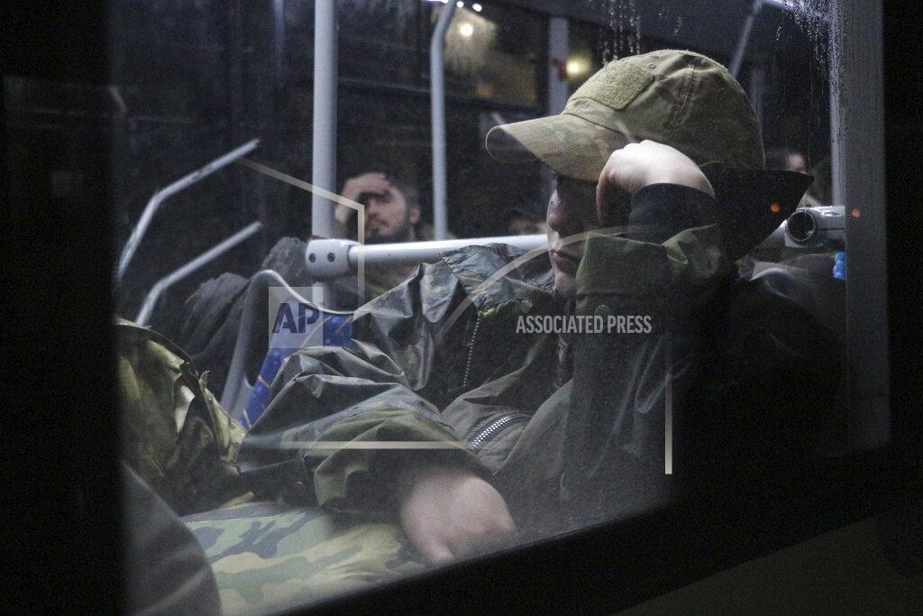 Uncredited Ukrainian servicemen sit in a bus after leaving Mariupol's besieged Azovstal steel plant, near a penal colony, in Olyonivka, in territory under the government of the Donetsk People's Republic, eastern Ukraine, Friday, May 20, 2022. (AP Photo)