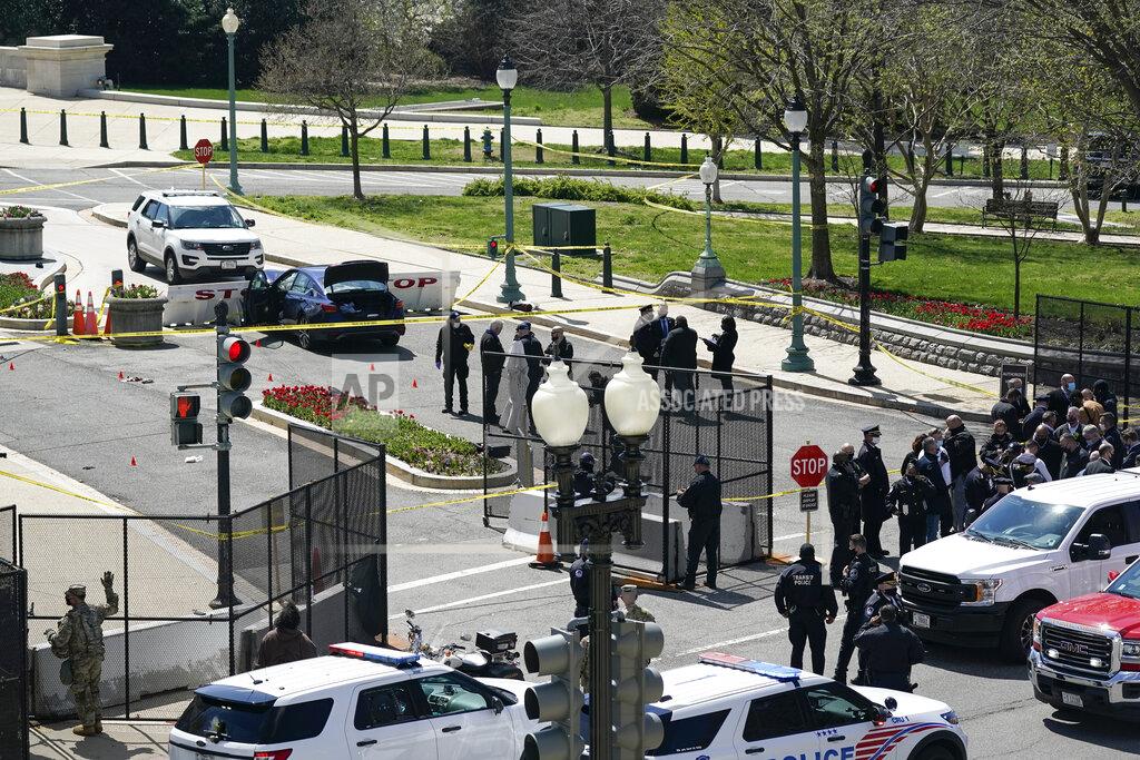 J. Scott Applewhite U.S. Capitol Police officers investigate near a car that crashed into a barrier on Capitol Hill near the Senate side of the U.S. Capitol in Washington, Friday, April 2, 2021. (AP Photo/J. Scott Applewhite)