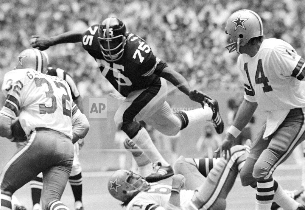 Ferd Kaufman FILE - In this Oct. 8, 1972, file photo, Pittsburgh Steelers left tackle Joe Greene (75) takes a short cut over Dallas Cowboys guard Blaine Nye (61) to put a sudden halt on Cowboys' Walt Garrison (32) during a football game in Irving, Texas. The beginning of the Pittsburgh Steelers dynasty of the 1970s can be pinpointed to the drafting of defensive lineman Joe Greene in 1969. (AP Photo/Fred Kaufman, File)