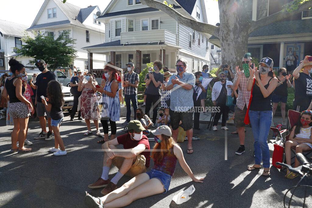 Kathy Willens FILE - People applaud while listening to an outdoor concert in Brooklyn's Ditmas Park neighborhood during the coronavirus outbreak, Sunday, June 21, 2020, in New York. Experts point out that violent crime has remained stable and low. In many major cities, there was looting and some property destruction during the height of the George Floyd racial justice protests, but order was restored months ago in most places, including New York. (AP Photo/Kathy Willens, File)