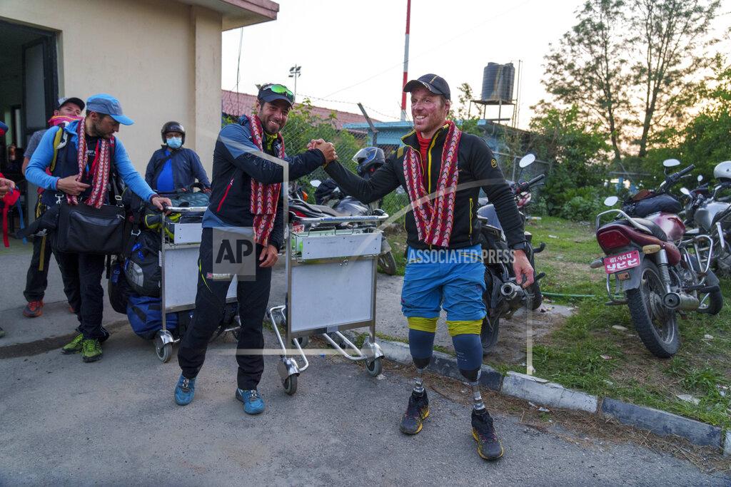 Niranjan Shrestha Italian climber Andrea Lanfri, 36, gestures as he arrives at the airport in Kathmandu, Nepal, Tuesday, May 17, 2022. Multiple-amputee Lanfri summited Everest successfully on May 13. Hundreds of climbers who scaled Mount Everest over the last few days taking advantage of favorable weather conditions have begun to return safely down the mountain. (AP Photo/Niranjan Shrestha)