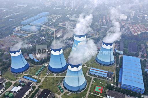 FILE - In this Sept. 27, 2021 file photo, steam billows out of the cooling towers at a coal-fired power station in Nanjing in east China's Jiangsu province. The world's facing an energy crunch. Europe is feeling it worst as natural gas prices skyrocket to five times normal, forcing some factories to hold back production. Reserves depleted last winter haven't been made up, and chief supplier Russia has held back on supplying extra. Meanwhile, the new Nord Stream 2 gas pipeline won't start operating in time to help if the weather is cold, and there's talk Europe could wind up rationing electricity. China is feeling it too, seeing power outages in some towns. (Chinatopix via AP, file)