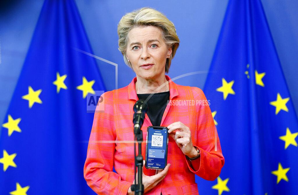 Johanna Geron European Commission President Ursula von der Leyen shows a phone, as she gives a press statement on the new COVID-19 digital travel certificate at the European Commission headquarters in Brussels, Wednesday, June 16, 2021. (Johanna Geron/Pool Photo via AP)