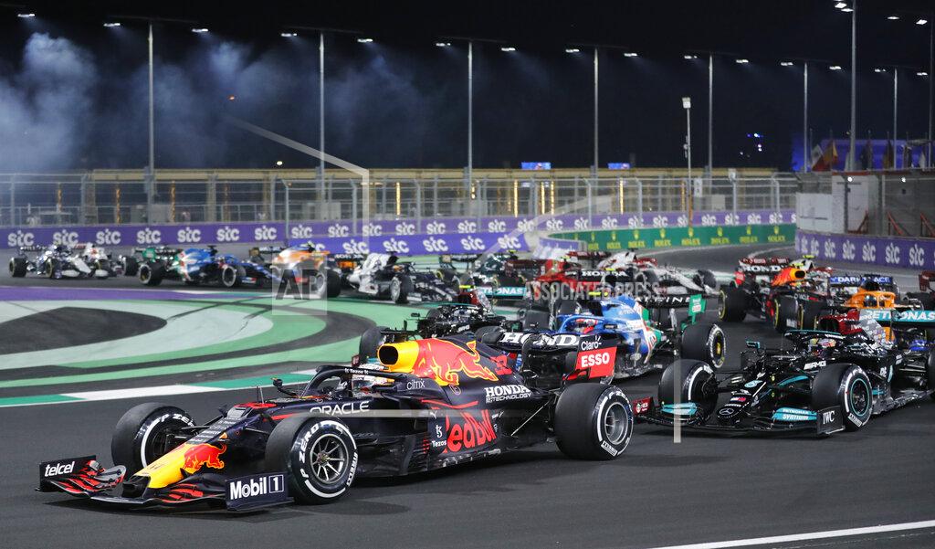 Amr Nabil Red Bull driver Max Verstappen of the Netherlands in action in front of Mercedes driver Lewis Hamilton of Britain during the Formula One corniche circuit, in Jiddah, Saudi Arabia, Sunday, Dec. 5, 2021. (AP Photo/Amr Nabil)