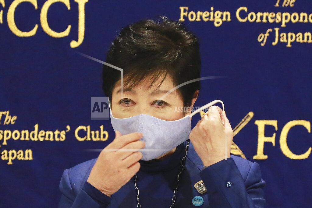 Koji Sasahara Tokyo Gov. Yuriko Koike takes off her mask as she speaks at a news conference in Tokyo, Tuesday, Nov. 24, 2020. Koike remains firm about being able to safely hold the Olympics next year despite growing concerns about Japan's recent resurgence of COVID-19 infections. (AP Photo/Koji Sasahara)