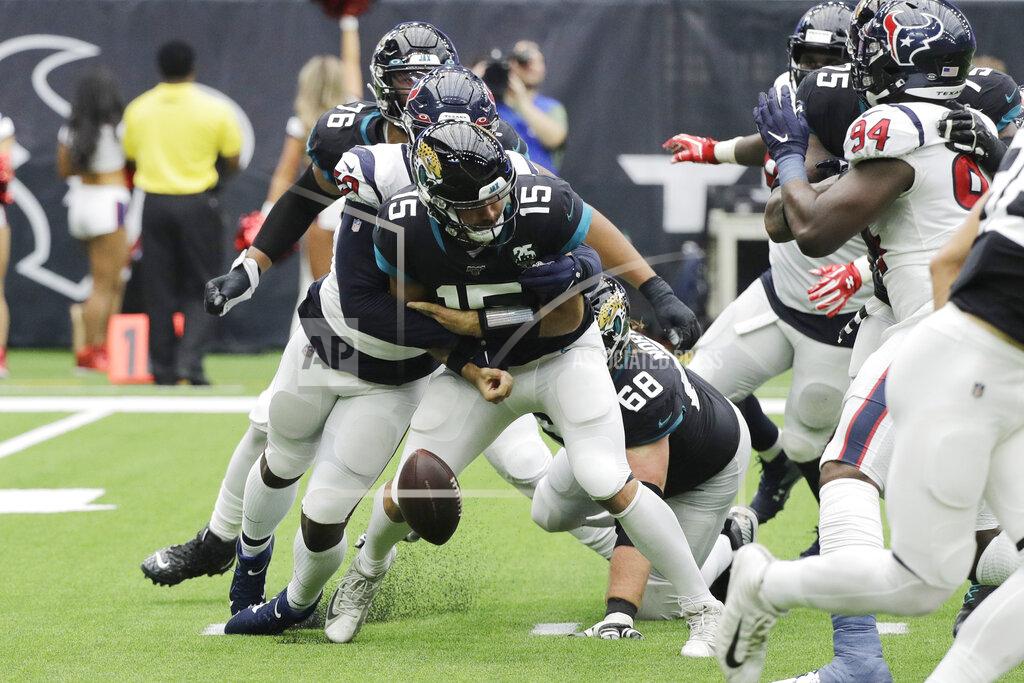 David J. Phillip Jacksonville Jaguars quarterback Gardner Minshew (15) fumbles as he is hit by Houston Texans outside linebacker Whitney Mercilus (59) during the second half of an NFL football game Sunday, Sept. 15, 2019, in Houston. (AP Photo/David J. Phillip)