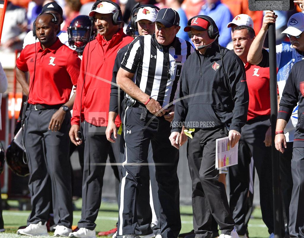 Richard Shiro Louisville head coach Bobby Petrino talks with an official during the first half of an NCAA college football game against Clemson, Saturday, Nov. 3, 2018, in Clemson, S.C. (AP Photo/Richard Shiro)