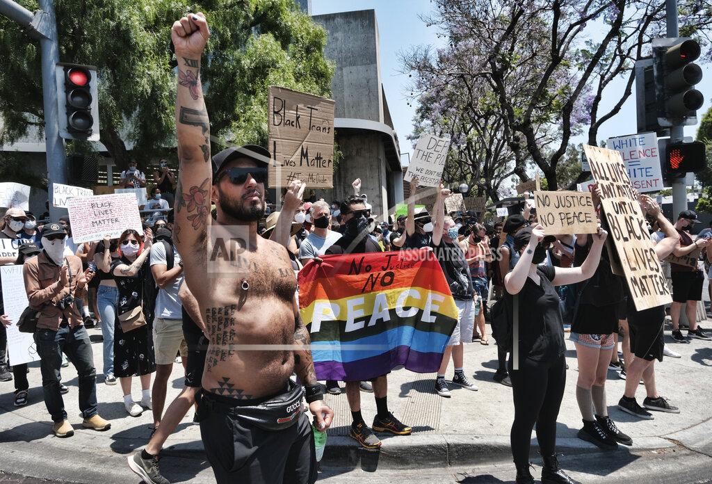 Richard Vogel LGBTQ community members join Black Lives Matter protesters holding signs and chanting slogans on an intersection in West Hollywood, Calif. on Wednesday, June 3, 2020, over the death of George Floyd, a black man who washing detained by police in Minneapolis. Floyd died after being restrained by Minneapolis police officers on Memorial Day. (AP Photo/Richard Vogel)