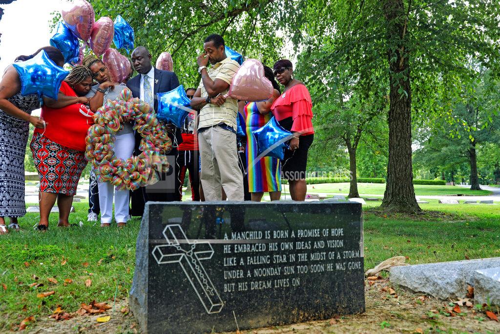 Laurie Skrivan FILE - In this Friday, Aug. 9, 2019 file photo, Lesley McSpadden, the mother of Michael Brown, prays with a group from Rainbow of Mothers, before placing a large wreath at her son's grave on the fifth anniversary of this death, at St. Peter's Cemetery in St. Louis. At left is Samaria Rice, the mother of Tamir Rice, who was killed by police in 2014 in Ohio. At center is Ben Crump, her attorney, and at right, her husband, Louis Head. (Laurie Skrivan/St. Louis Post-Dispatch via AP)